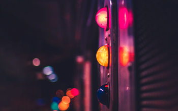 Traffic light with neon lights in background