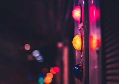Traffic light with neon lights in background