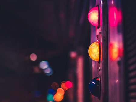 Traffic light with neon lights in background