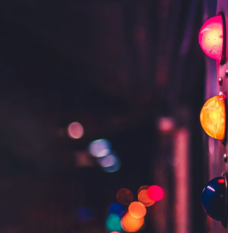 Traffic light with neon lights in background