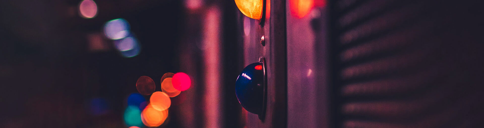 Traffic light with neon lights in background