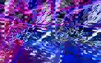 Bridge lit at night with neon pink and purple lighting