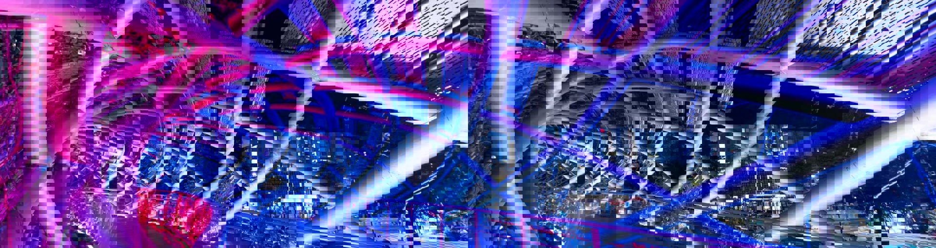 Bridge lit at night with neon pink and purple lighting