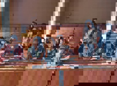 Young people sitting and talking in a lecture room