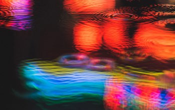 Neon light reflections in puddle