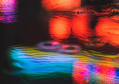 Neon light reflections in puddle