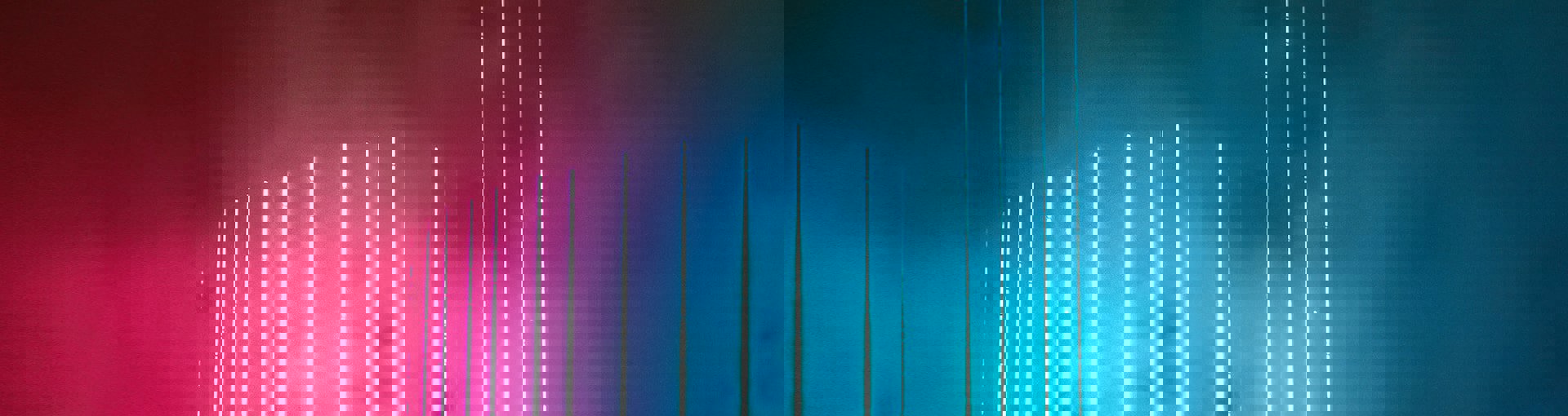 Modern high rise building with blue neon lights vertically along the building front