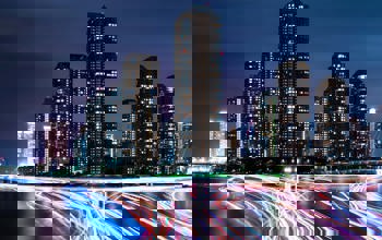 City at night with neon car trails 