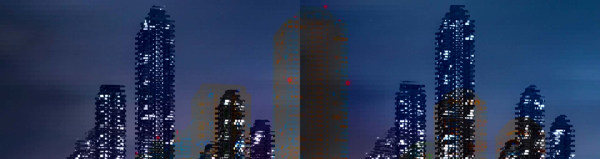 City at night with neon car trails 