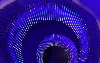 View of spiral staircase in neon blue lighting