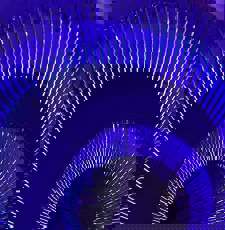 View of spiral staircase in neon blue lighting