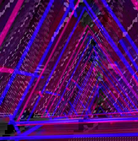 Neon lighting in trianble shapes layered on top of each other