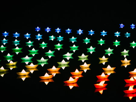 Image of neon stars in blue, green and red on a black background