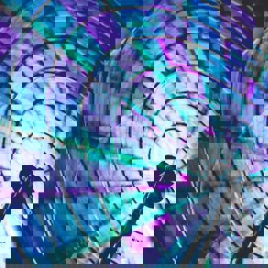 Neon blue green and purple ferris wheel spinning