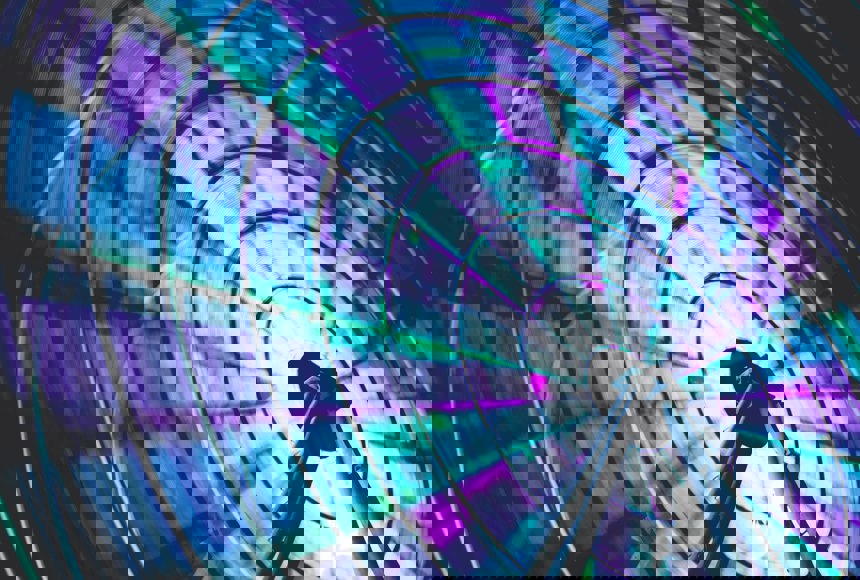 Neon blue green and purple ferris wheel spinning