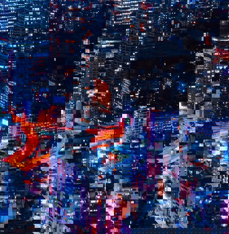 Nightime view of city with neon orange lighting up the roads