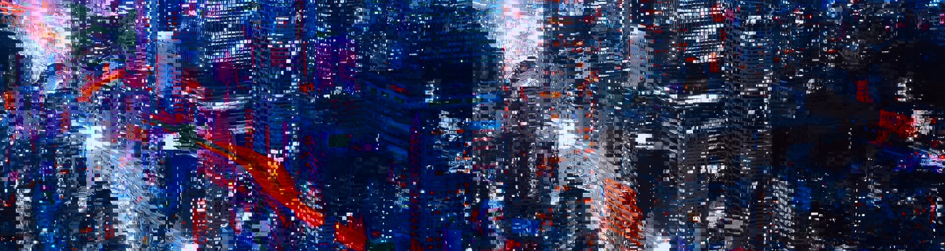 Nightime view of city with neon orange lighting up the roads