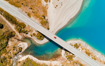 Bridge over water near a sandy shore