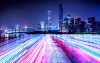 Neon lit cityscape with linse going to horizon