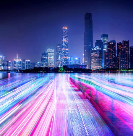Neon lit cityscape with linse going to horizon
