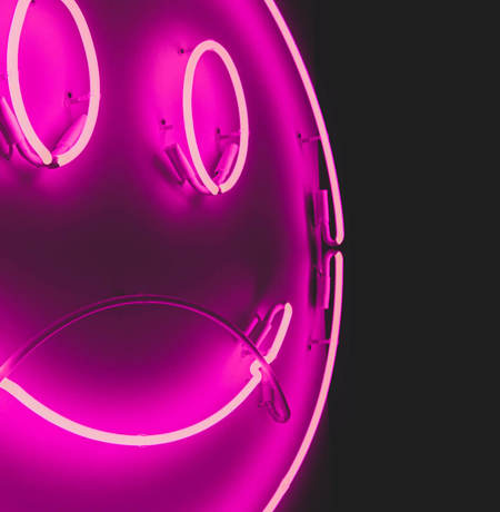 Neon light with smily face and purple background
