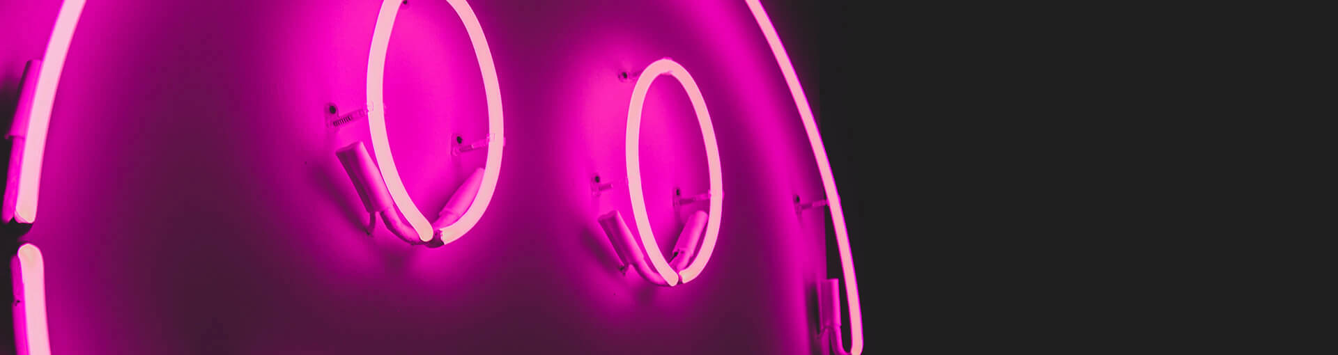 Neon light with smily face and purple background