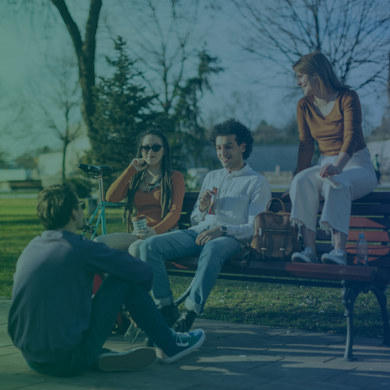 Youths sitting on a bench in a park - 1720 X 1030
