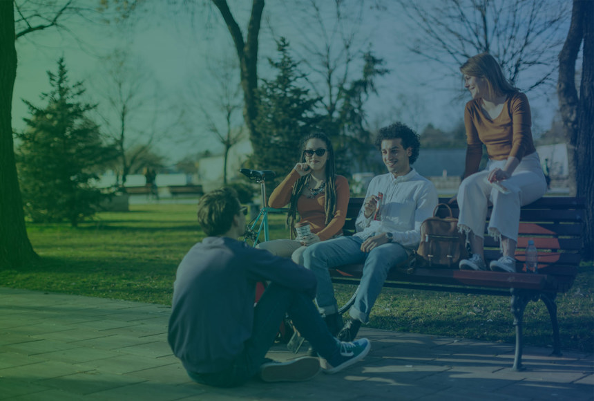 Youths sitting on a bench in a park - 1720 X 1030