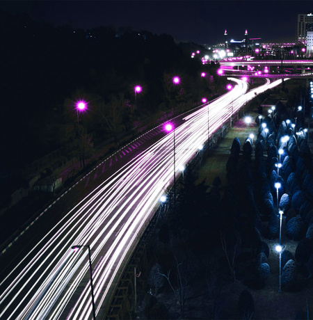 Image of highway with neon lights from car trails