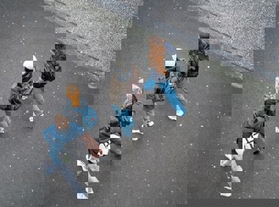 A row of young people walking shot from a birds eye view