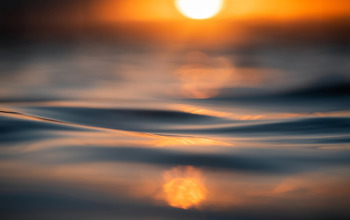 Sunset reflection in rippling water.