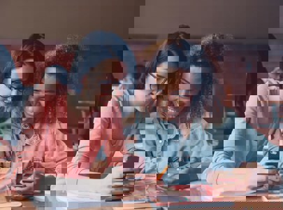 Young people looking at a phone in a classroom setting